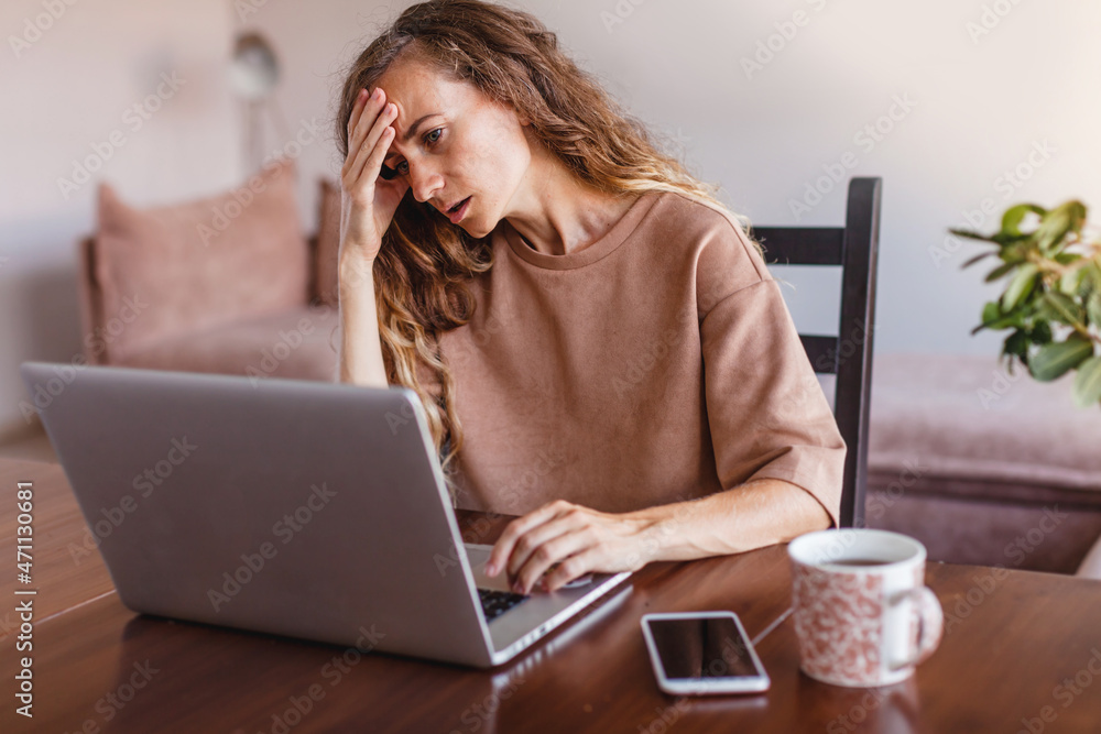 Fototapeta premium Frustrated upset woman freelancer has just got unpleasant bad news