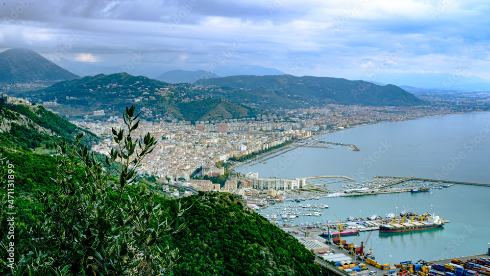 view from above of Salerno with harbor, piazza della libertà and mountains in the background