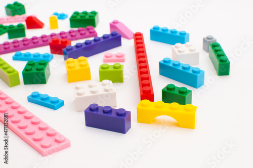 Various details of a plastic constructor for children of various bright colors on a white background.