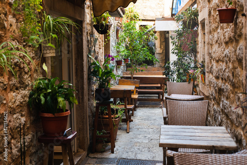 Cozy street cafe in a narrow street in the old town. Empty cafe. Budva, Montenegro.