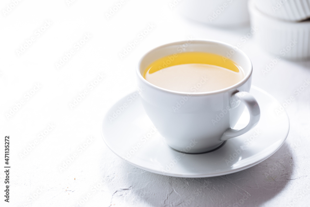 Cup of tea in white cup with chocolate chip cookies as a part of a scene, on a white background Cup of tea in white cup with chocolate chip cookies as a part of a scene, on a white background