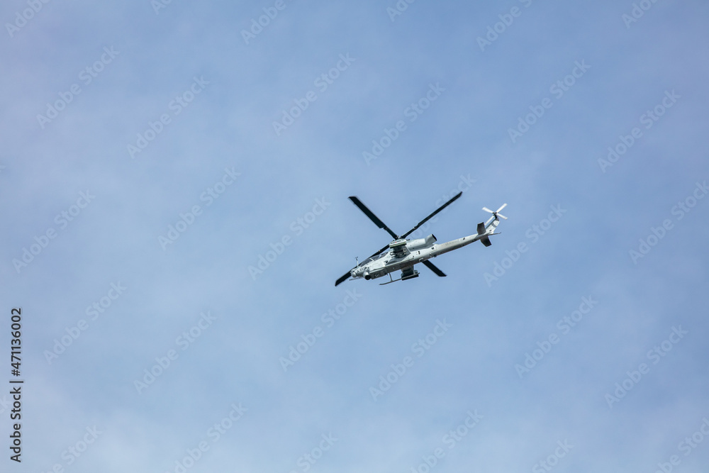 An Apache Helicopter Flying Overhead in a Blue Sky on a Training Mission in California An Apache Helicopter Flying Overhead in a Blue Sky on a Training Mission in California