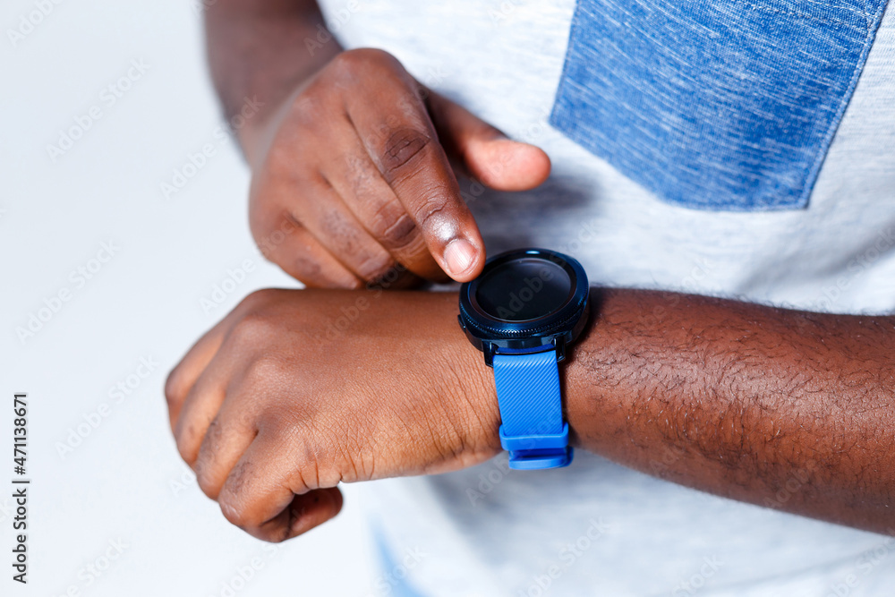 A person is pointing to his new blue clock. A person is pointing to his new blue clock.