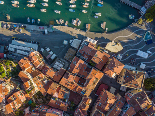 Aerial view of old town in mediterranean city with red roofs and narrow streets