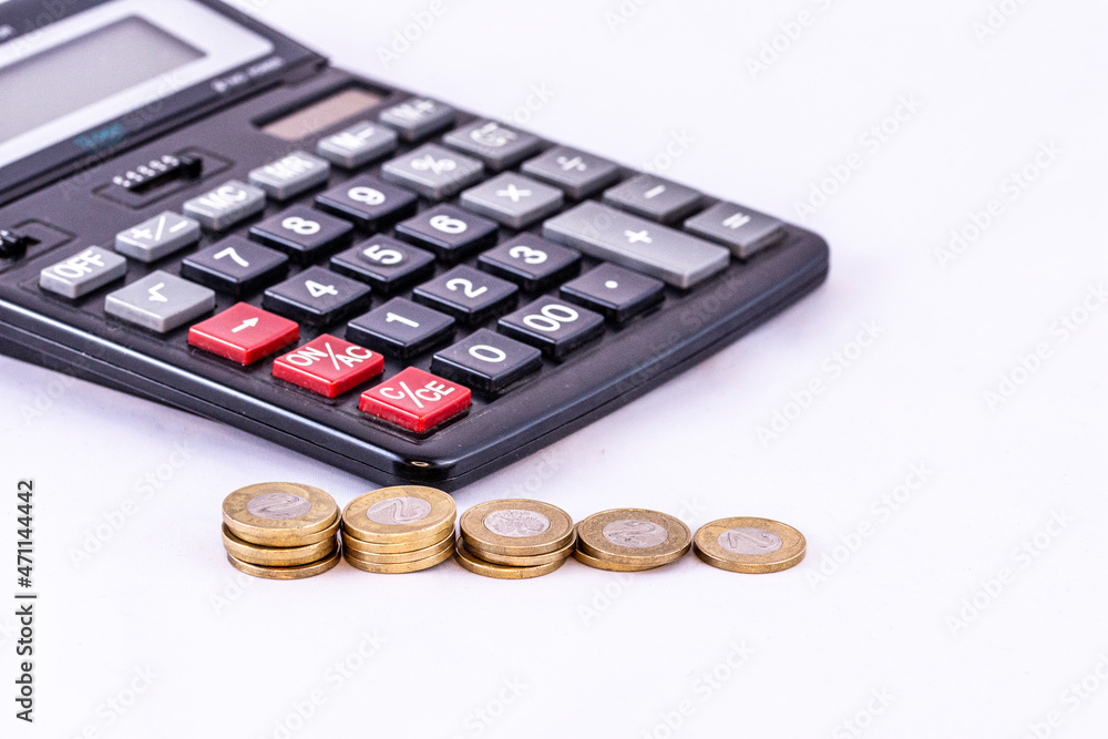 Coins and calculator on an isolated white background. Money. Coins and calculator on an isolated white background. Money.