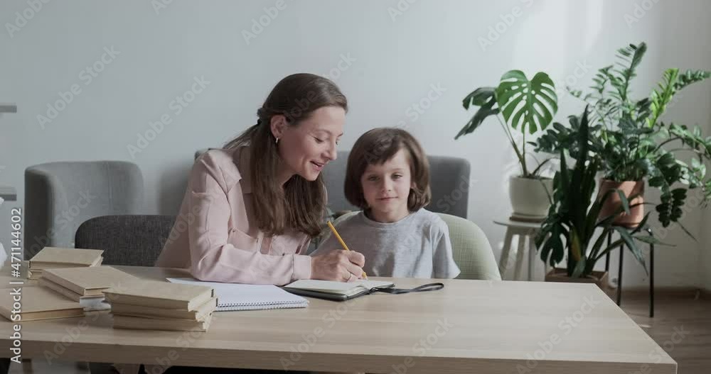 Loving mother tries to teach her restless, active son, who has difficulty concentrating in class. Attention deficit hyperactivity disorder ADHD syndrome. Loving mother tries to teach her restless, active son, who has difficulty concentrating in class. Attention deficit hyperactivity disorder ADHD syndrome.