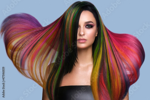 Beautiful woman with multi-colored hair and creative make up and hairstyle. Beauty face. photo