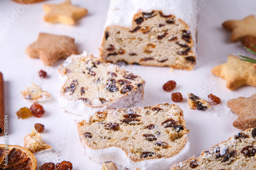 Classical Stollen is a Traditional German Cake with raisins on white background with place for text. Fruit cake for the Holiday.