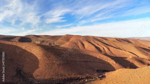 Panorama of hills with regular brown soil pattern in Tizi'n-Tinififft pass Ouaourmas Morocco, blue sky above