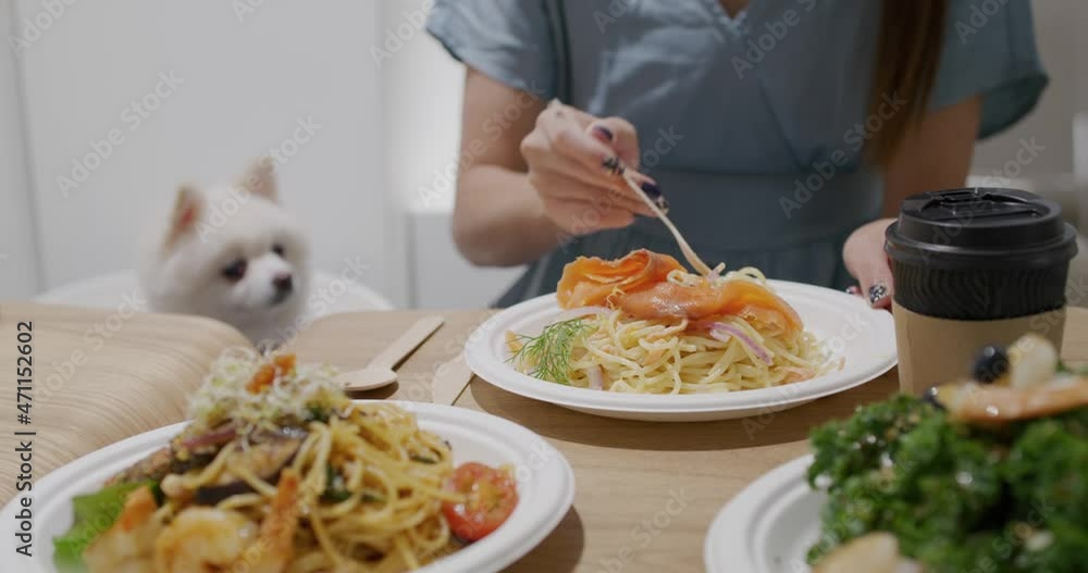 Woman enjoy the meat in pet friendly restaurant Woman enjoy the meat in pet friendly restaurant