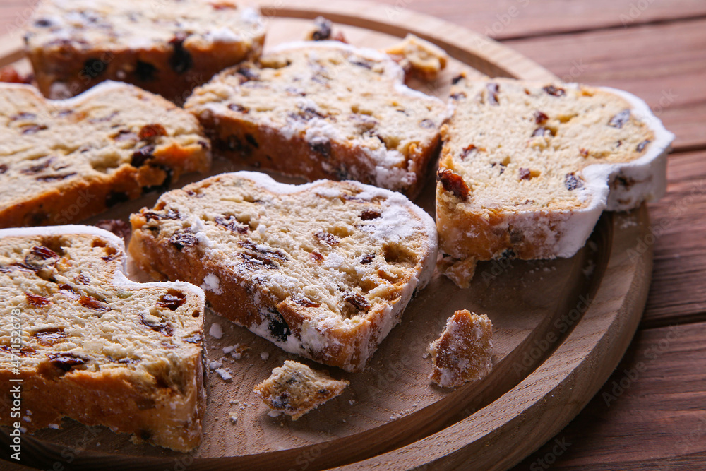Dresdner Stollen is a Traditional German Cake with raisins on wooden background Fruit cake for the Holiday.