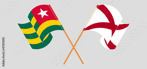 Crossed and waving flags of Togo and The State of Alabama