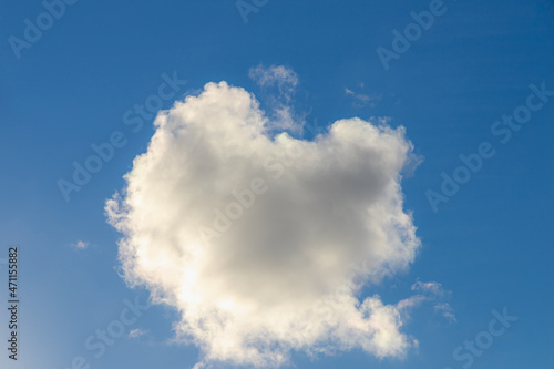 Beautiful white fluffy cloud floating in blue sky in sunny day  Cumulus are clouds which have flat bases and are often described as puffy  Horizon nature background.