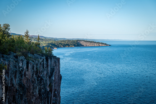 Beautiful landscape along the north shore of Lake Superior in Minnesota, from Palisade Head, a natural sheer cliff at the edge of the blue water. Evening image at the shore of Gitchi-Gami.