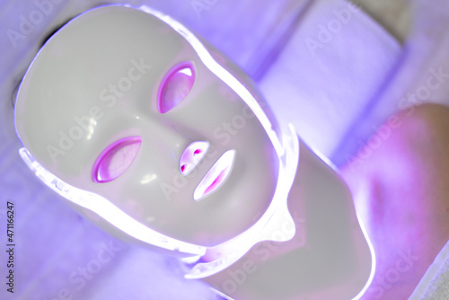 LED mask regenerative treatment applied to a young woman