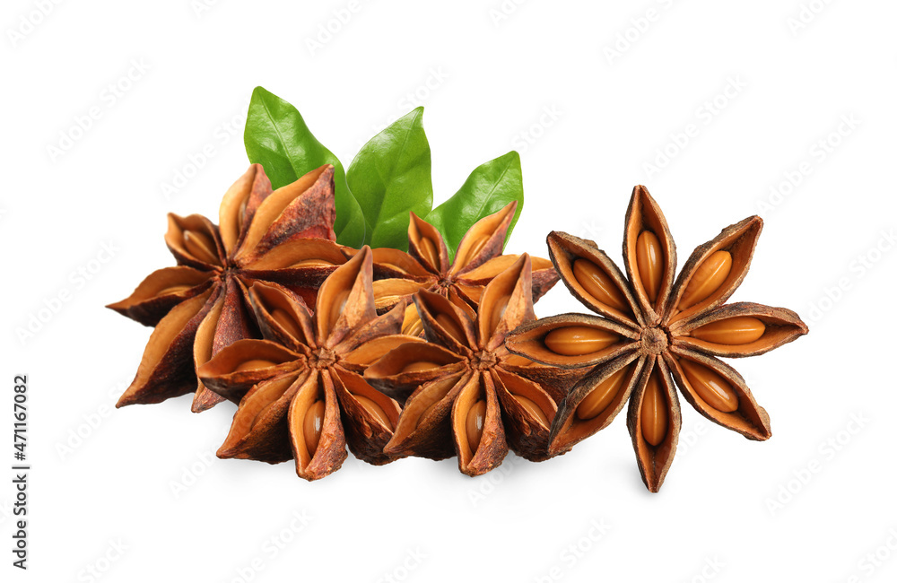 Aromatic dry anise stars and green leaves on white background Aromatic dry anise stars and green leaves on white background