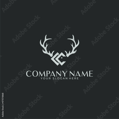 Logo negative space deer antlers with a house in a rustic style and CC monogram