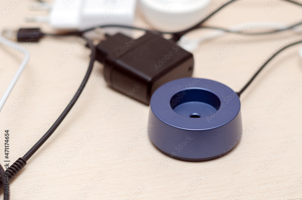 on the table is a round blue charger for an electric toothbrush on the table is a round blue charger for an electric toothbrush