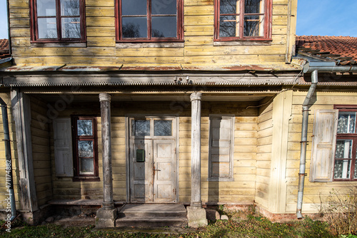 Historical wooden house with old wooden doors, wood carvings and columns. Kuldiga, Latvia