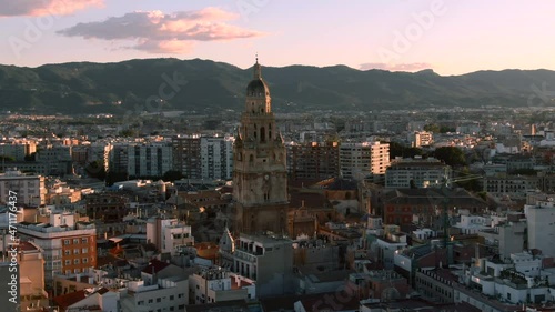 Close up aerial shot of Murcia Cathedral in Spain. Mountain cityscape view photo