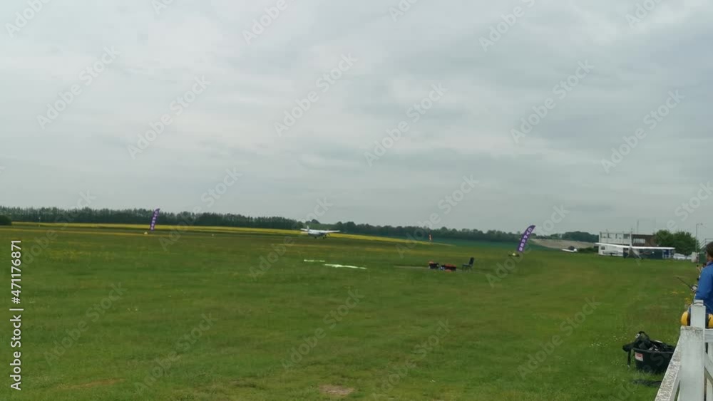 A small and short plane take off from a grassy runway in england A small and short plane take off from a grassy runway in england