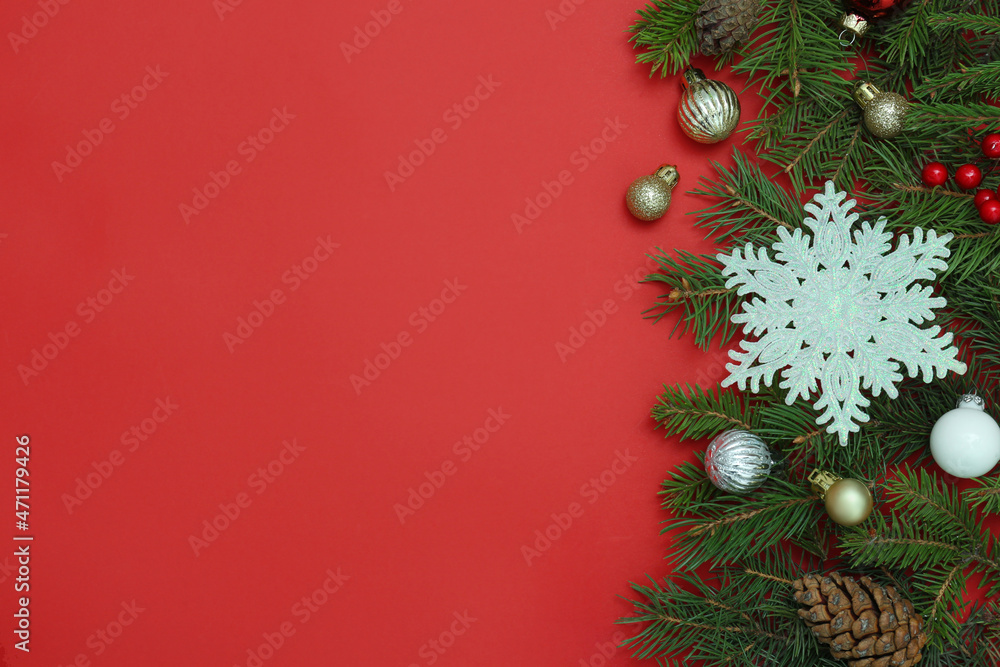 Flat lay composition with Christmas decor on red background, space for text