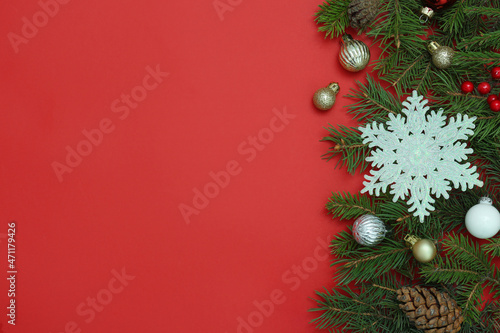 Flat lay composition with Christmas decor on red background  space for text