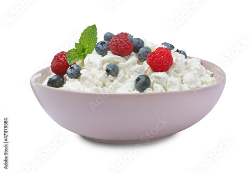 Fresh cottage cheese with berries and mint in bowl isolated on white