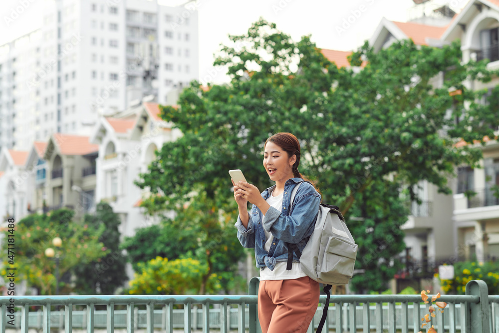 Young student using a smartphone in a park Young student using a smartphone in a park