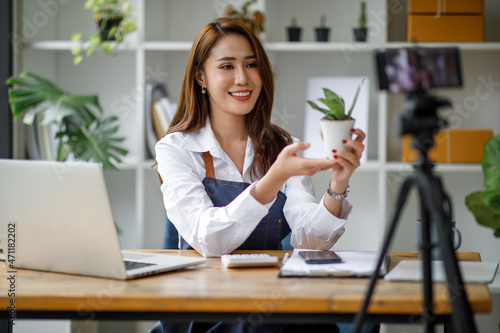 Portrait of Asian young woman SME working with a box at home the workplace.start-up small business owner, small business entrepreneur SME or freelance business online and delivery concept.