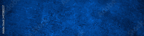 Dark blue abstract background. Toned concrete wall surface texture. Dark blue rough background with copy space for design. Web banner. Website header.