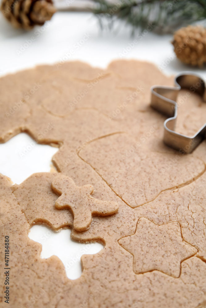 Homemade Christmas biscuits. Raw dough and cookie cutter on white table, closeup