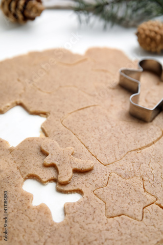 Homemade Christmas biscuits. Raw dough and cookie cutter on white table, closeup