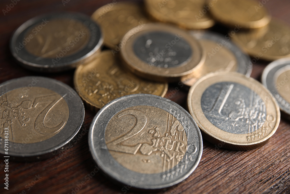 Many Euro coins on wooden table, closeup Many Euro coins on wooden table, closeup