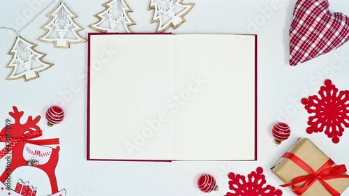 Opened book for text and cute decorations for Christmas on white theme. Stop motion