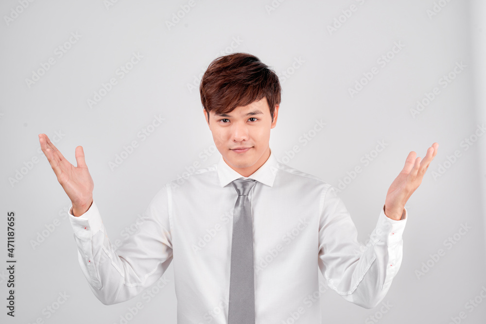 Excited surprised handsome young Asian man in casual white shirt doing open hand gesture Excited surprised handsome young Asian man in casual white shirt doing open hand gesture