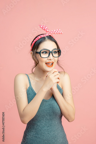 Lovable girl good news reaction isolated over pink background