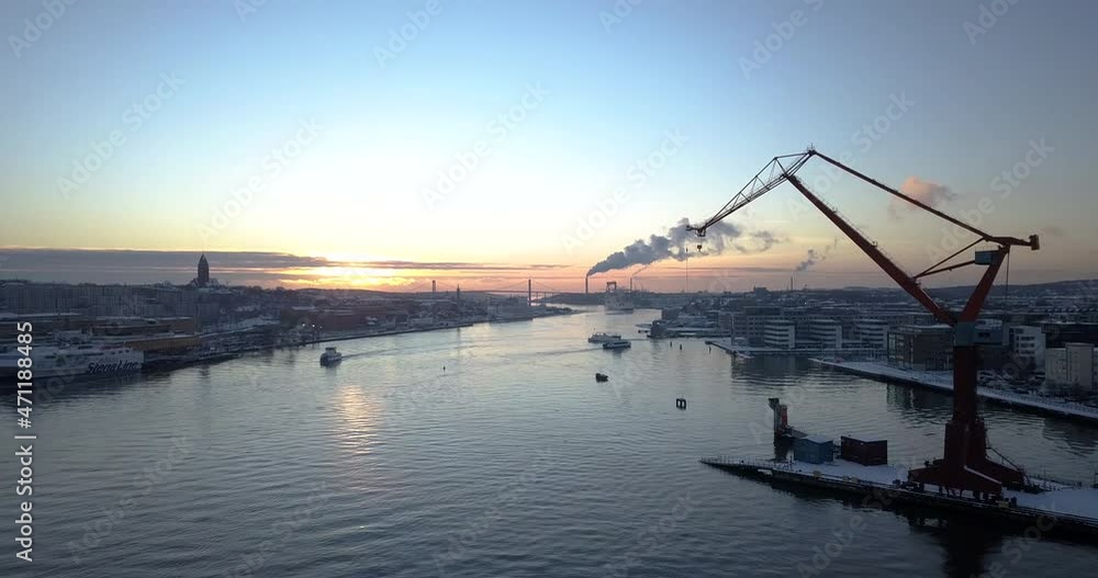 Boats Cruising At Gota Alv River At Dockland Area Of Lindholmen With Double Jib Cranes In Gothenburg, Sweden. - aerial Boats Cruising At Gota Alv River At Dockland Area Of Lindholmen With Double Jib Cranes In Gothenburg, Sweden. - aerial