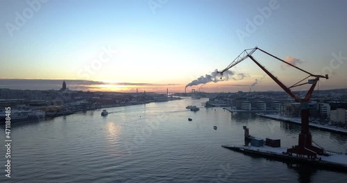 Boats Cruising At Gota Alv River At Dockland Area Of Lindholmen With Double Jib Cranes In Gothenburg, Sweden. - aerial photo