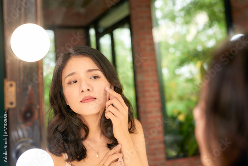 Asian woman having the trouble on her skin