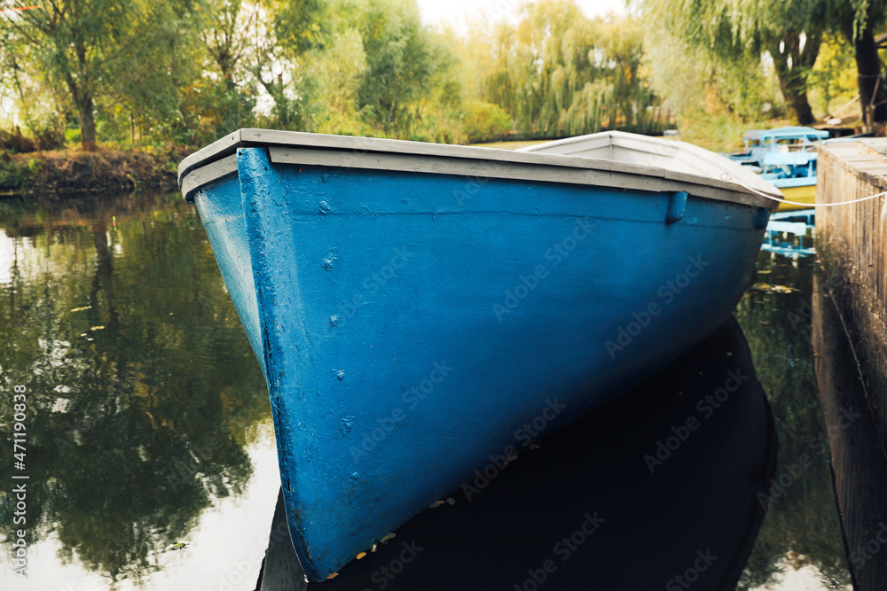 Light blue wooden boat on lake, closeup Light blue wooden boat on lake, closeup