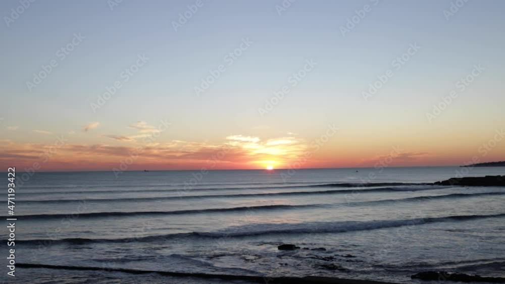 amazing sunset over sea with surfers and boats amazing sunset over sea with surfers and boats