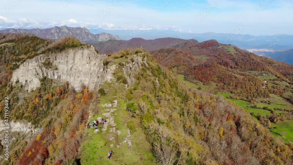 Aerial: narrow plateau and mountain range in autumn season. Forest with trees in yellowish colours, surrounding mountains and the snow covered Pyrenees in the background Aerial: narrow plateau and mountain range in autumn season. Forest with trees in yellowish colours, surrounding mountains and the snow covered Pyrenees in the background