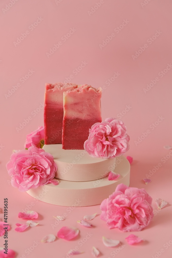Rose soap. Beauty and aromatherapy. Flower soap. Pink soap bars and pink roses on podium on pink background. Soap with Rose extract .Organic vegan eco cosmetics. Rose soap. Beauty and aromatherapy. Flower soap. Pink soap bars and pink roses on podium on pink background. Soap with Rose extract .Organic vegan eco cosmetics.