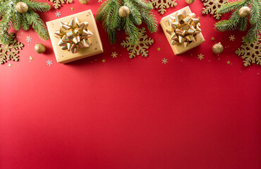 Christmas and new year background concept. Top view of Christmas decoration made from gift box, snowflake, christmas ball and  pine branches on red background.