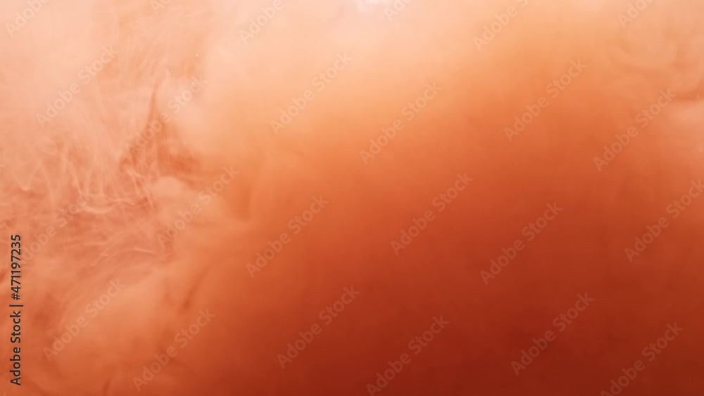 Large cloud of pale scarlet color paint in transparent water as decorative abstract background slow motion extreme closeup Large cloud of pale scarlet color paint in transparent water as decorative abstract background slow motion extreme closeup