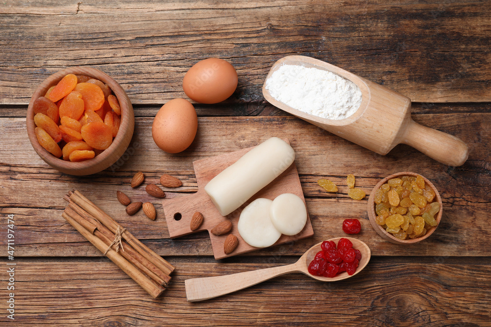 Marzipan and other ingredients for homemade Stollen on wooden table, flat lay. Baking traditional German Christmas bread Marzipan and other ingredients for homemade Stollen on wooden table, flat lay. Baking traditional German Christmas bread