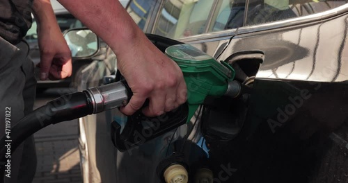 Fuel station nozzle filling car tank