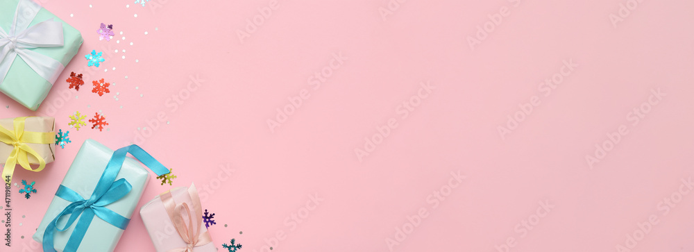 Christmas gifts and confetti on pink background with space for text Christmas gifts and confetti on pink background with space for text