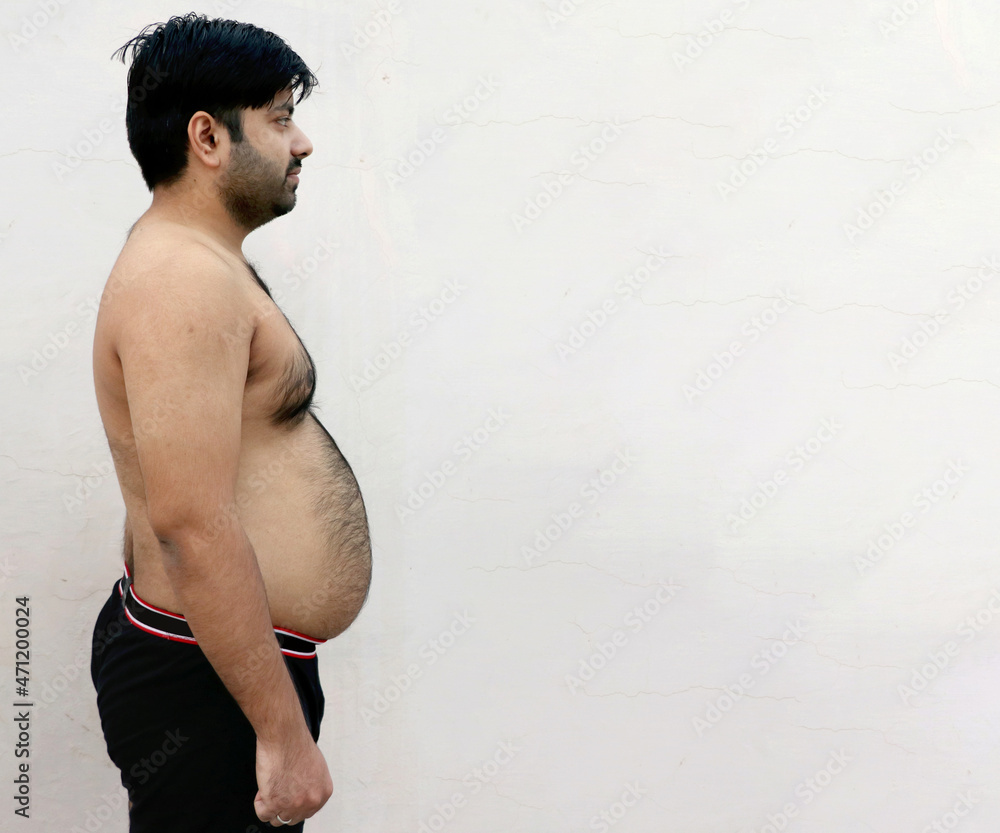 Obraz premium Portrait of a asian fat man show out his body and big belly.